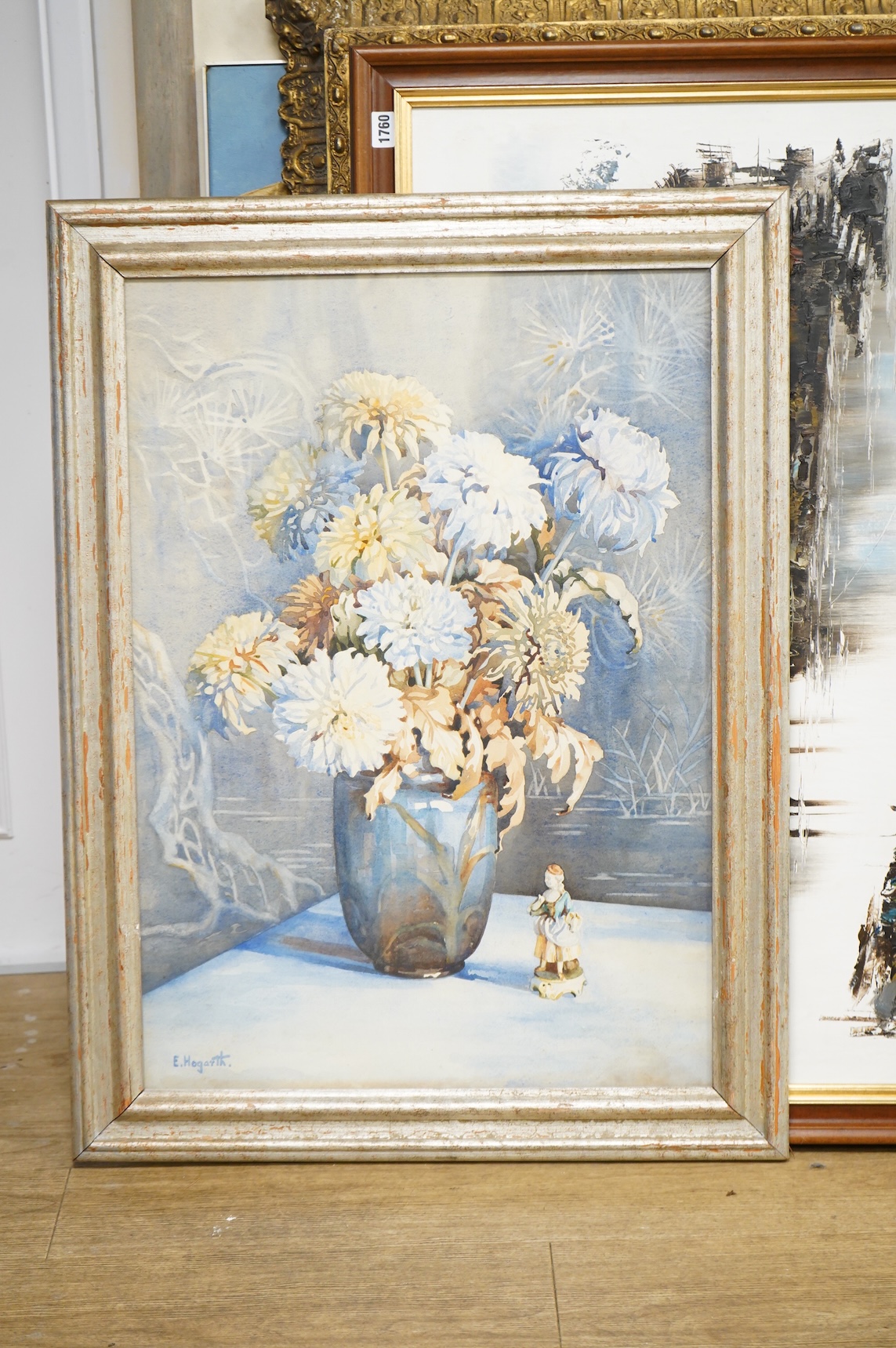 E. Hogarth, Still life of a vase with chrysanthemums and china figures, signed, watercolour, 74 x 51cm